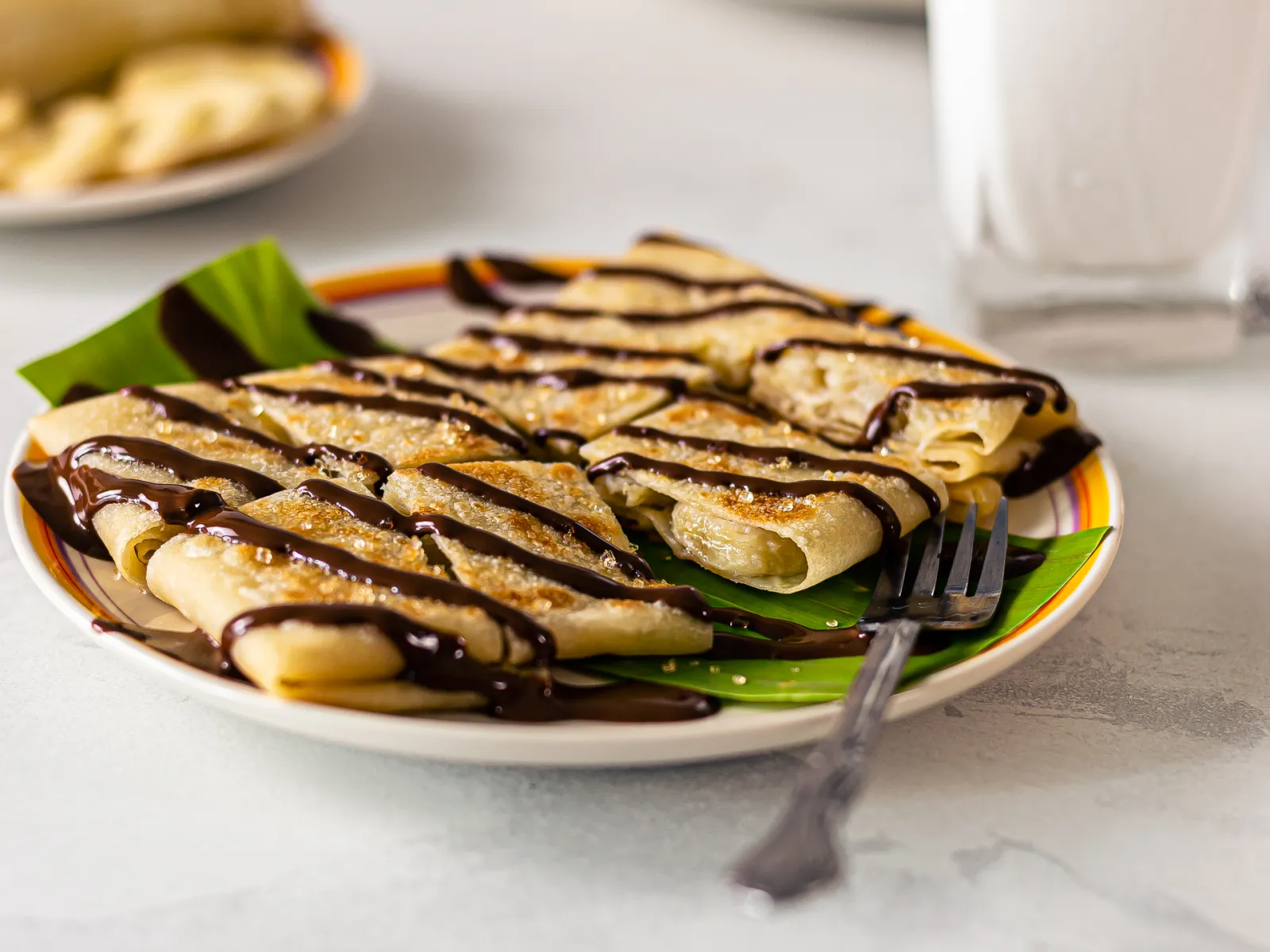 https://cdn.foodaciously.com/static/recipes/444af043-9256-4280-b235-058ced809efd/thai-banana-pancakes-with-chocolate-sauce-d144575a30e6581b8e4feb5e78be6474.jpg
